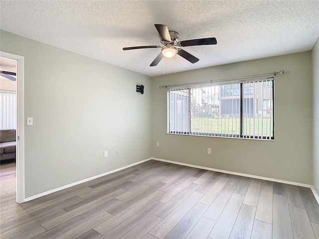 unfurnished room with a textured ceiling, hardwood / wood-style flooring, and ceiling fan