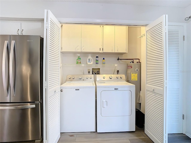 clothes washing area with electric water heater and separate washer and dryer