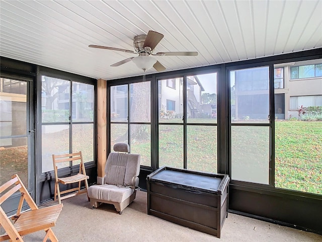 sunroom featuring ceiling fan and plenty of natural light