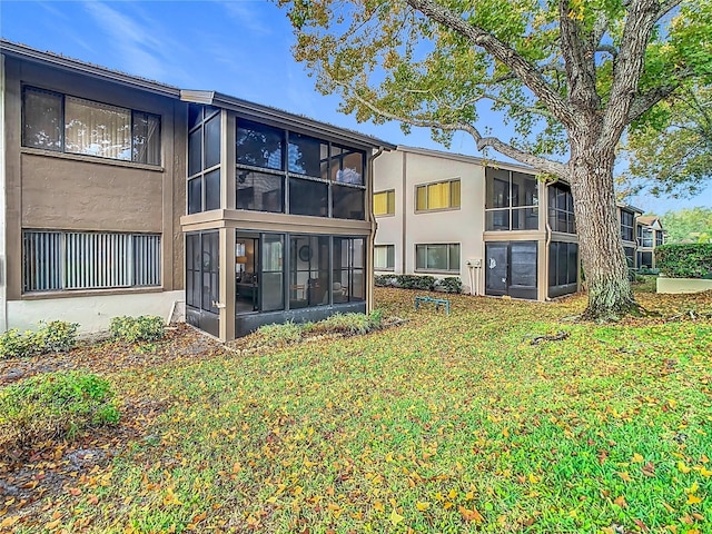 rear view of property with a lawn