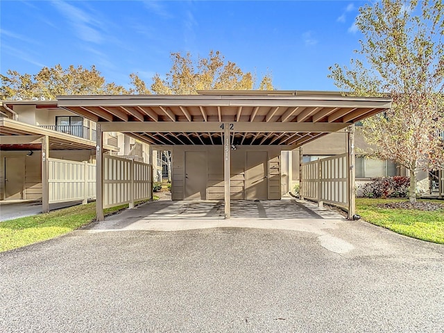 view of parking / parking lot featuring a carport