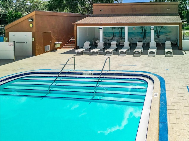 view of swimming pool featuring a patio area