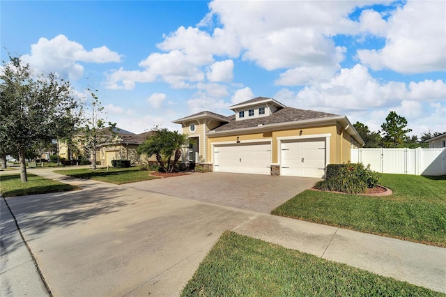 view of front of property featuring a front yard and a garage