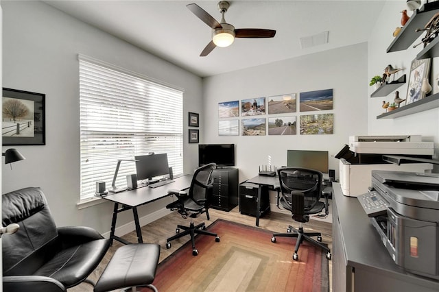 office space with light wood-type flooring and ceiling fan