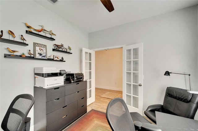 home office featuring ceiling fan, light wood-type flooring, and french doors