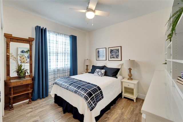 bedroom with ceiling fan and light hardwood / wood-style floors