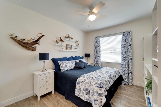 bedroom with light hardwood / wood-style floors and ceiling fan