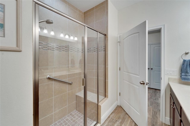 bathroom with vanity and a shower with door