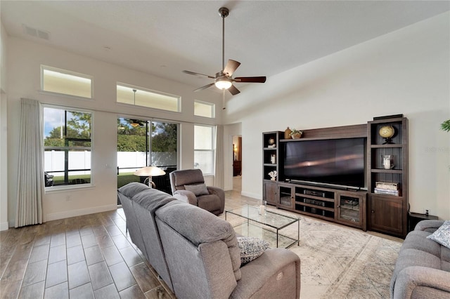 living room with ceiling fan and lofted ceiling