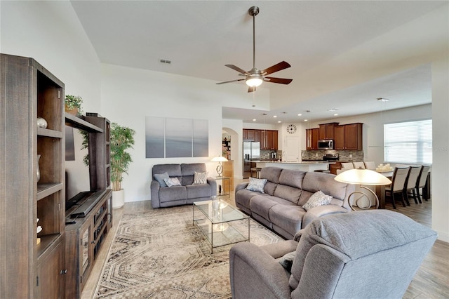 living room featuring ceiling fan and light hardwood / wood-style floors