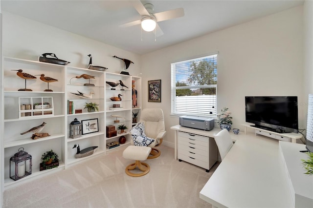 carpeted office space featuring ceiling fan