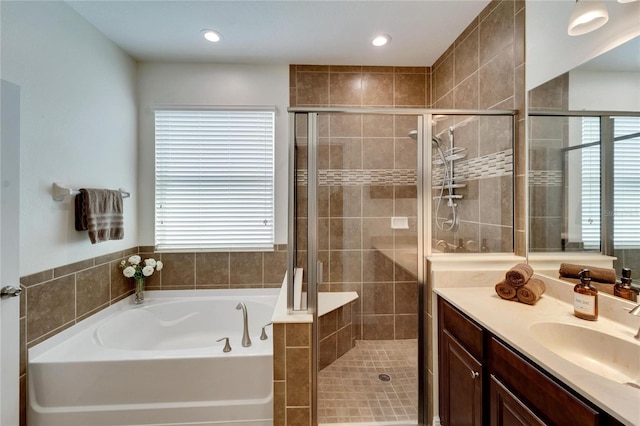 bathroom featuring vanity, a healthy amount of sunlight, and shower with separate bathtub