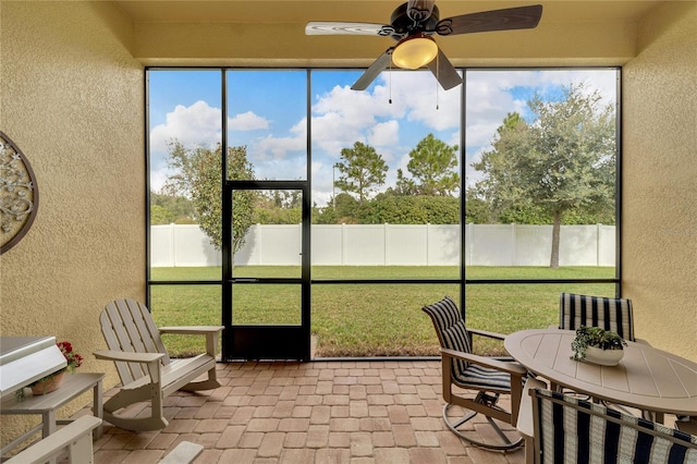 sunroom / solarium with a wealth of natural light and ceiling fan