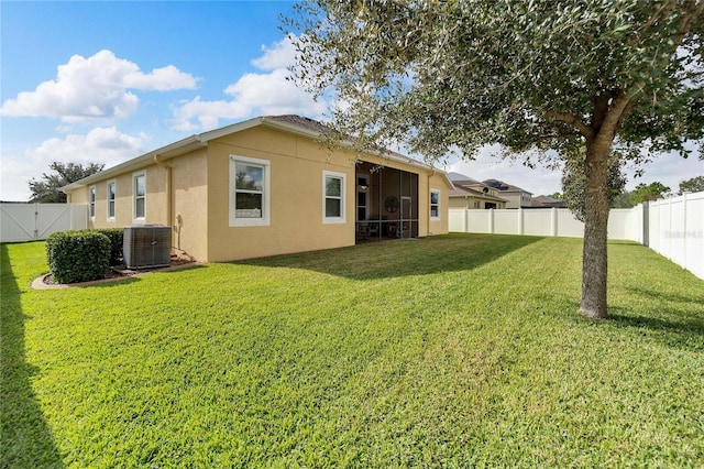 back of property featuring a lawn and central AC unit