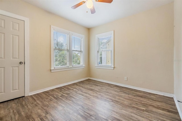 unfurnished room with ceiling fan and hardwood / wood-style floors