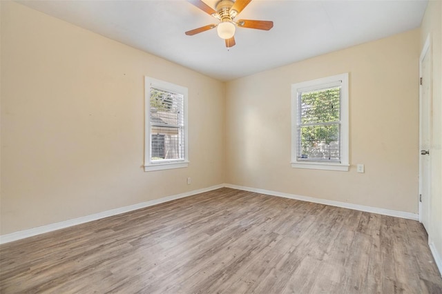 unfurnished room with ceiling fan and light wood-type flooring