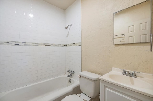 full bathroom with vanity, tiled shower / bath, and toilet