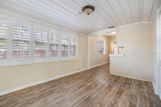 spare room featuring dark hardwood / wood-style flooring, ornamental molding, and wooden ceiling