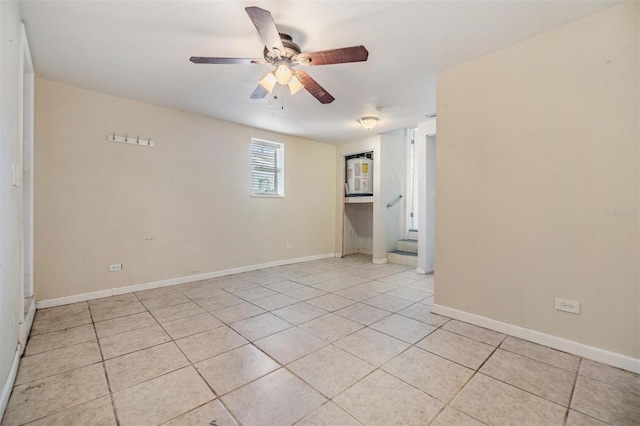 empty room featuring ceiling fan and light tile patterned floors