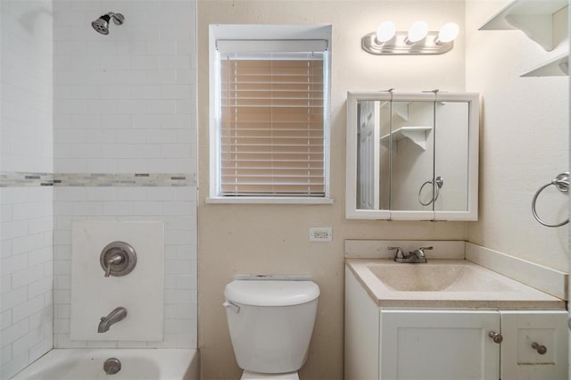 full bathroom with vanity, toilet, and tiled shower / bath