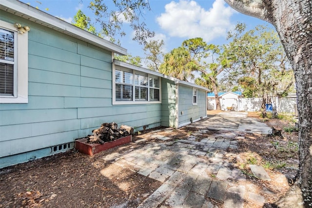 view of side of property with a patio area