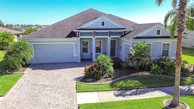 view of front of house with a front yard and a garage