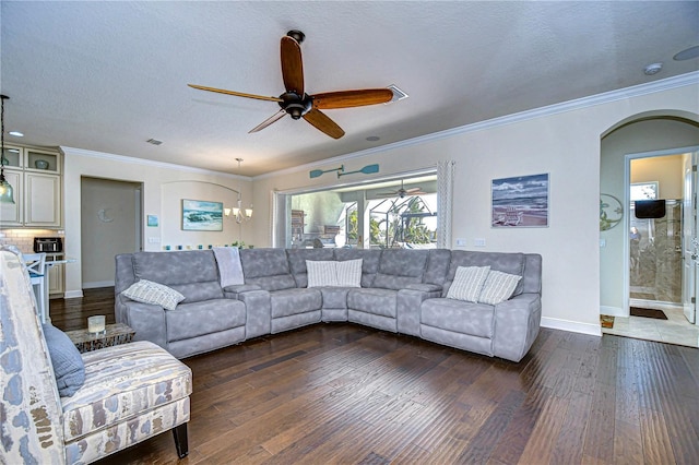 living room with ceiling fan, crown molding, a textured ceiling, and dark wood-type flooring