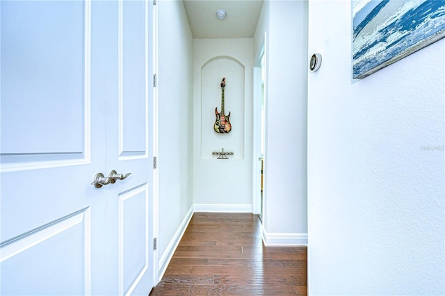 hall with dark wood-type flooring