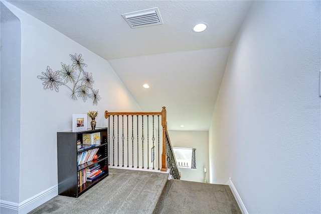 stairs with carpet floors and vaulted ceiling