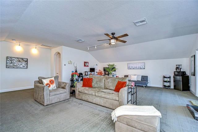 carpeted living room with ceiling fan, a textured ceiling, and vaulted ceiling