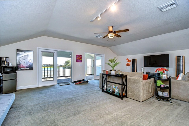 living room with ceiling fan, light carpet, and vaulted ceiling