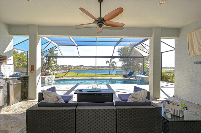 view of patio / terrace featuring a lanai, area for grilling, and a water view