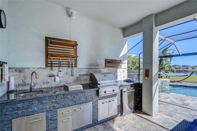 view of patio / terrace featuring a lanai, grilling area, sink, and exterior kitchen