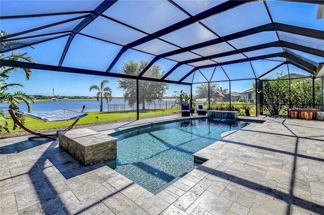 view of swimming pool featuring a yard, a patio, a water view, and a lanai