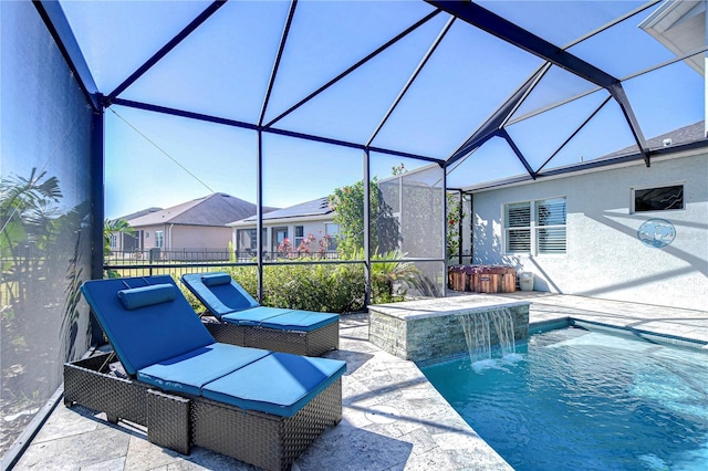 view of swimming pool with pool water feature, glass enclosure, and a patio