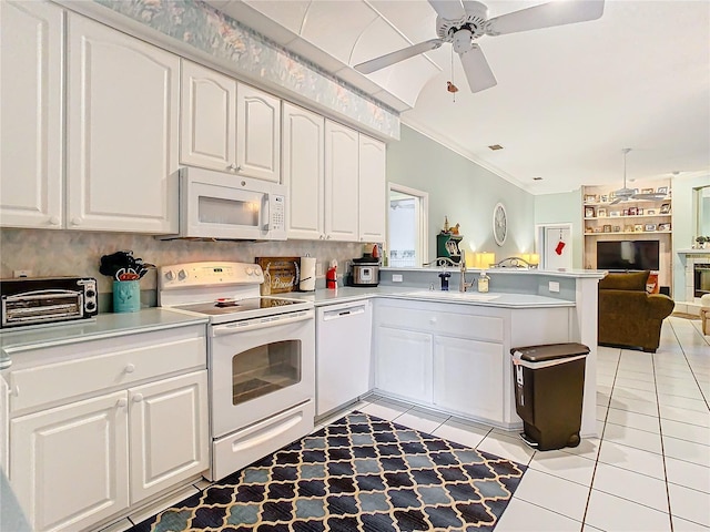 kitchen featuring white cabinetry, sink, white appliances, and kitchen peninsula