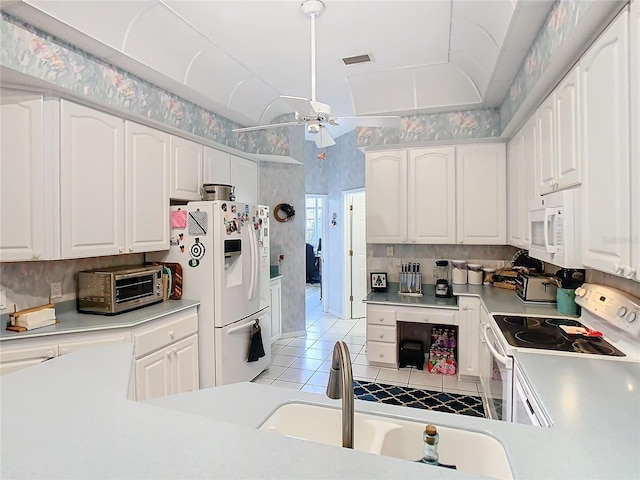 kitchen with ceiling fan, sink, white cabinets, white appliances, and light tile patterned floors