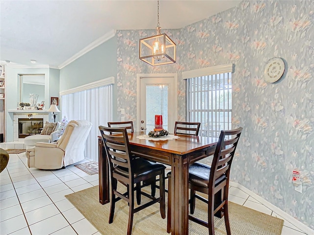 dining room with light tile patterned floors and ornamental molding