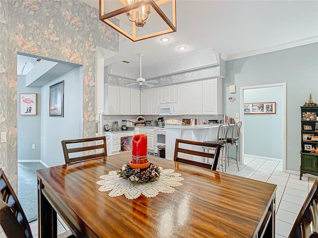 dining room with ceiling fan with notable chandelier, ornamental molding, and light tile patterned flooring