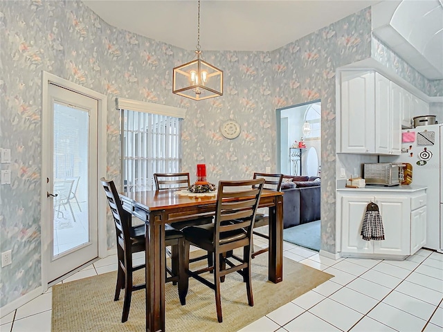 dining area with a wealth of natural light, light tile patterned floors, and a notable chandelier