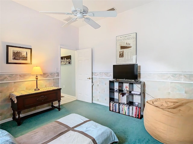 bedroom with carpet, ceiling fan, and tile walls