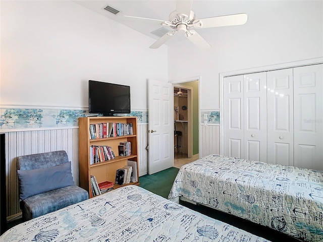 bedroom featuring carpet, ceiling fan, vaulted ceiling, and a closet