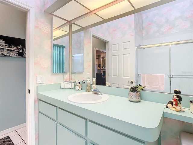 bathroom featuring tile patterned flooring, vanity, and walk in shower