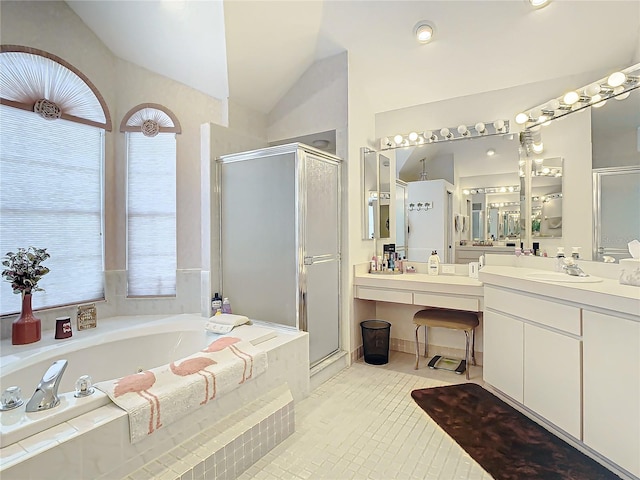 bathroom featuring tile patterned flooring, vanity, separate shower and tub, and lofted ceiling