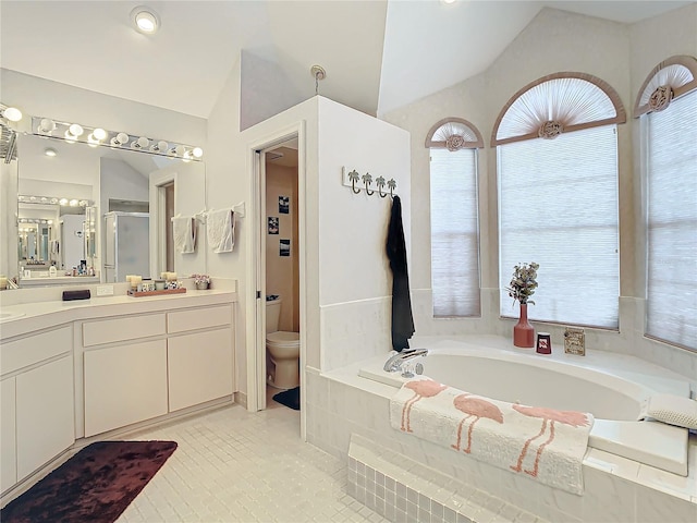 full bathroom with vanity, tile patterned floors, vaulted ceiling, separate shower and tub, and toilet