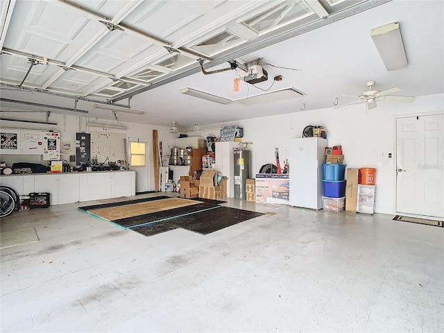 garage featuring ceiling fan, white refrigerator, a garage door opener, and water heater