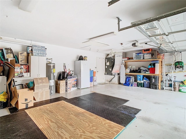 garage with heating unit, water heater, and white refrigerator