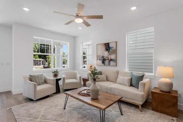 living room featuring ceiling fan and light hardwood / wood-style floors