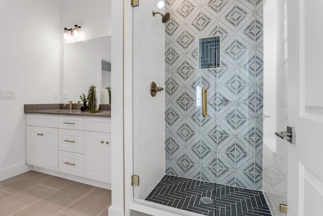 bathroom with tile patterned flooring, vanity, and a shower with shower door