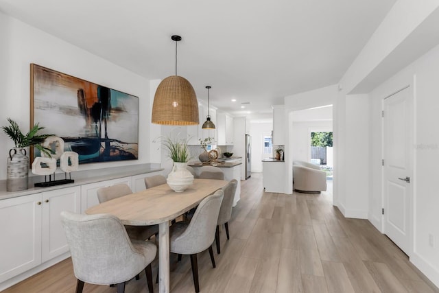 dining area featuring light wood-type flooring